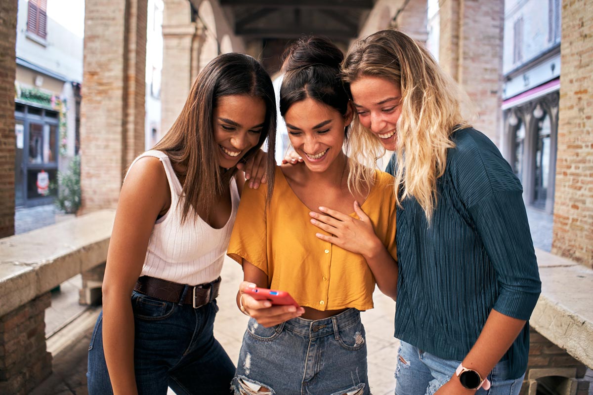 Happy teens looking at a phone